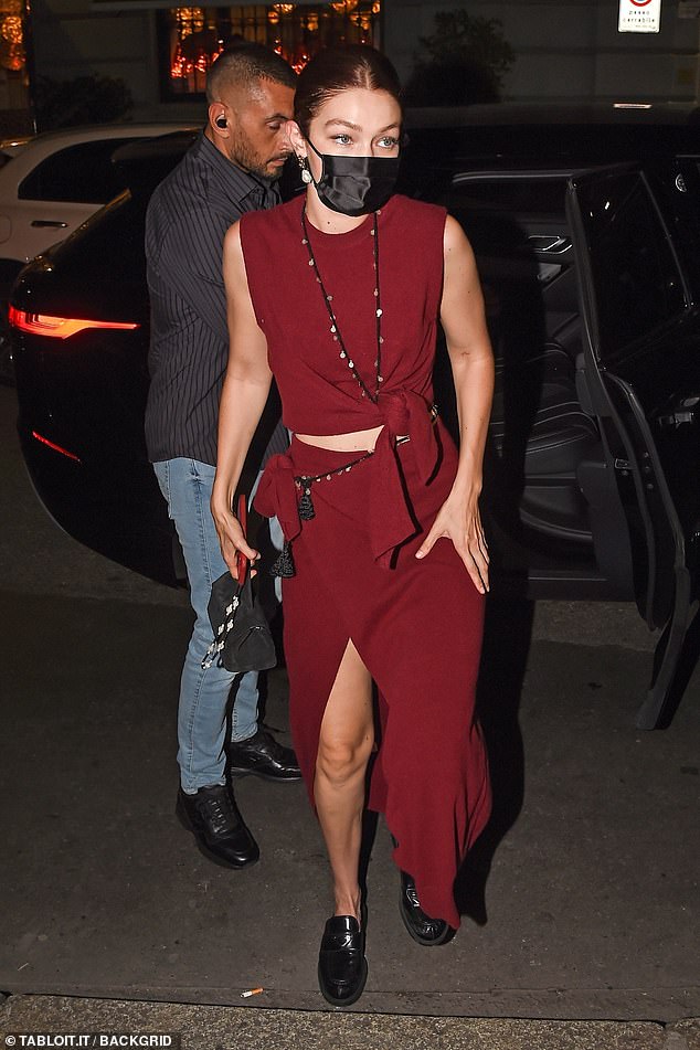 Chic: Gigi (pictured), 26, donned a burgundy midriff with tie detail and a matching maxi-skirt that also featured a daring thigh split. She added chunky black Prada loafers to the look