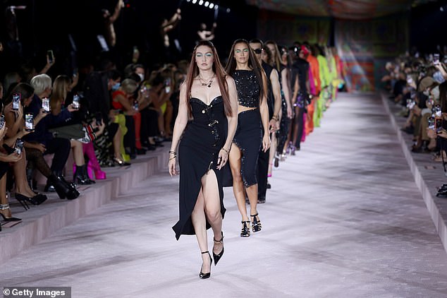 Leading the charge: Gigi strutted along, leading a line of models in an array of gowns