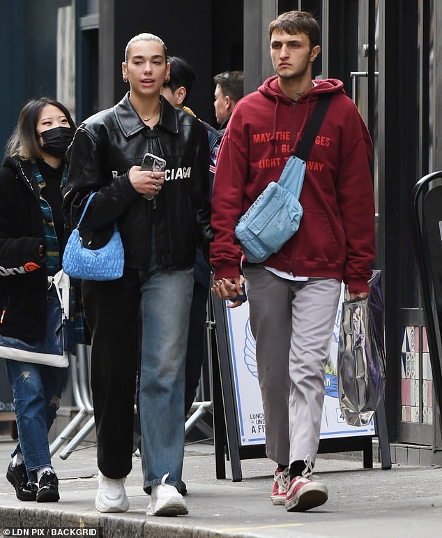 Hard to miss: The couple were hand in hand as they strolled through Soho, with Dua catching the eye in a £3,000 Balenciaga jacket