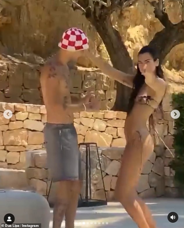 Devoted: In a sweet accompanying video, the New Rules hitmaker looked like she was having a whale of a time as she cut a snakeskin-printed bikini to dance poolside with her beau Anwar Hadid, 22