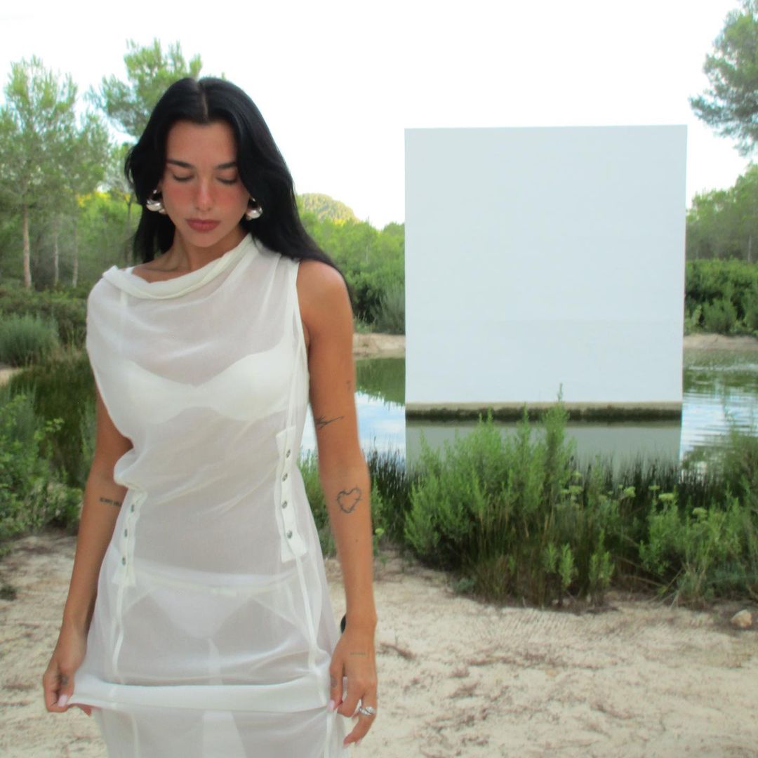 Dua Lipa has been seen posing beside a lake in a see-through dress
